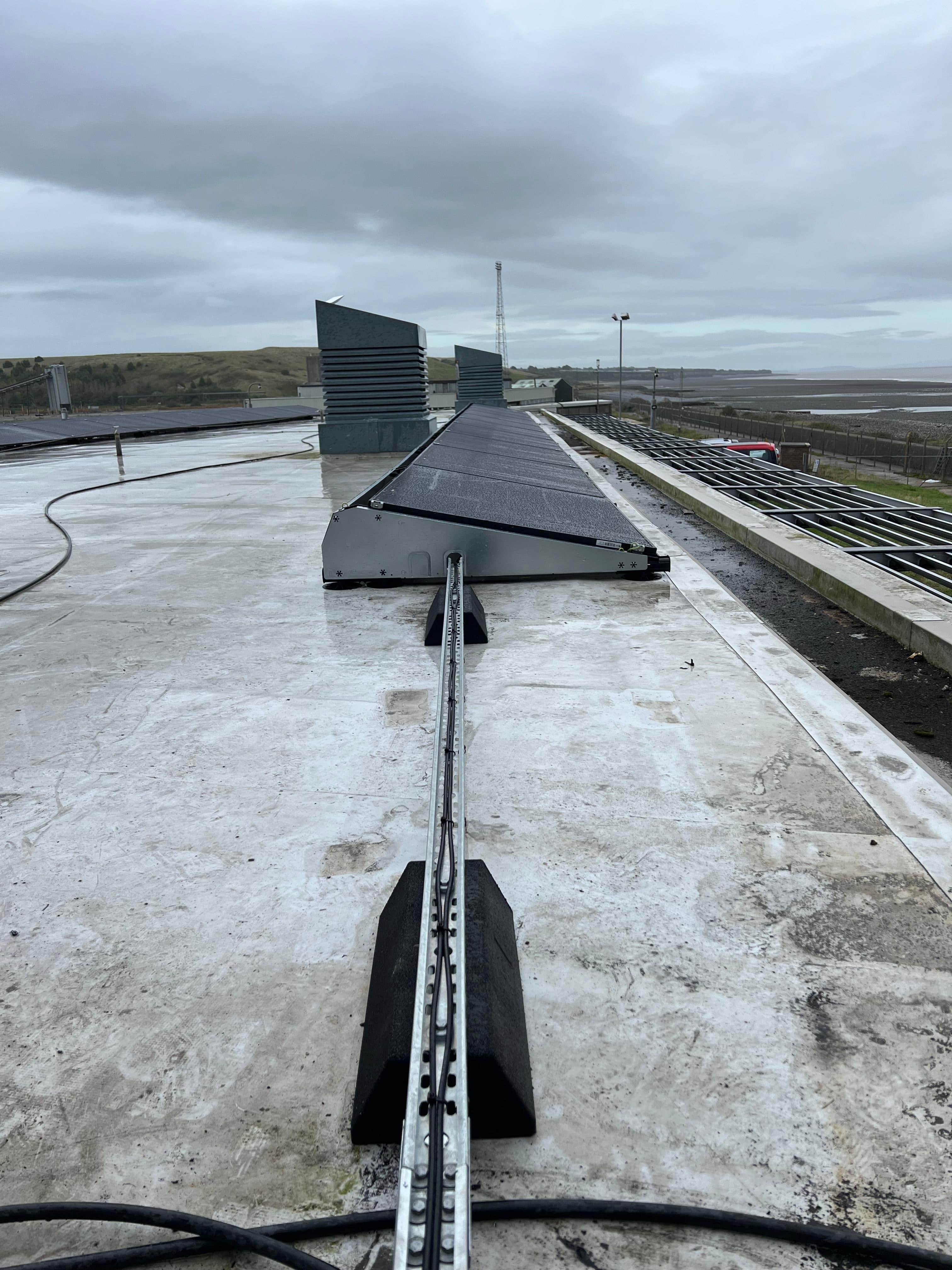 Tilted solar panels and cable management system on the flat roof at CCR Energy Aberthaw
