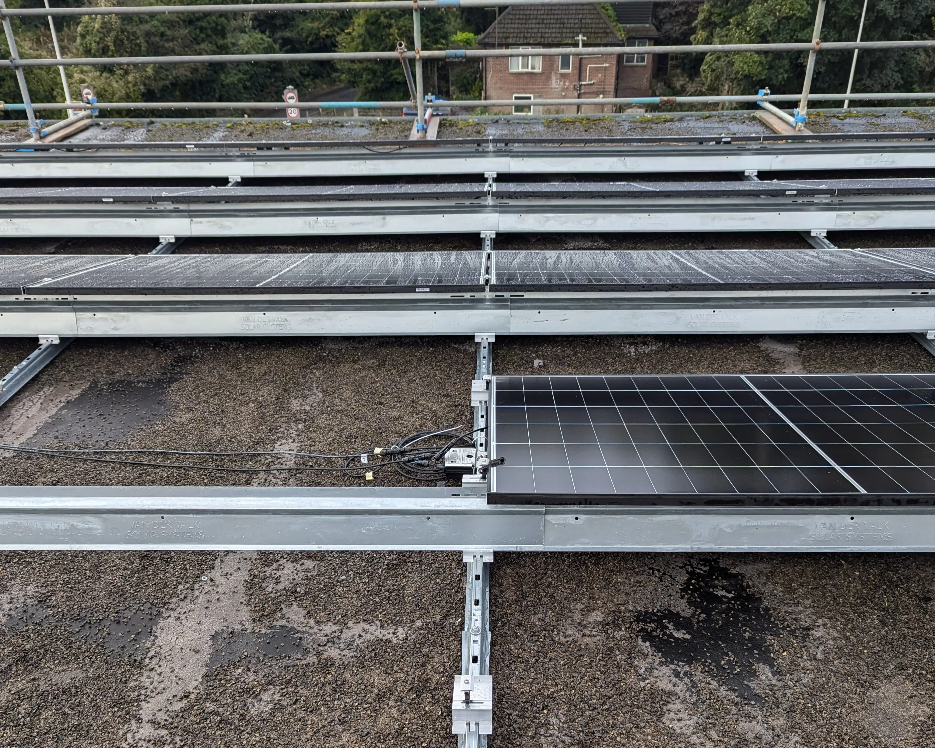 Close-up of the Van der Valk mounting system and panel wiring on the flat roof of iTec Skills' head office in Cardiff during installation