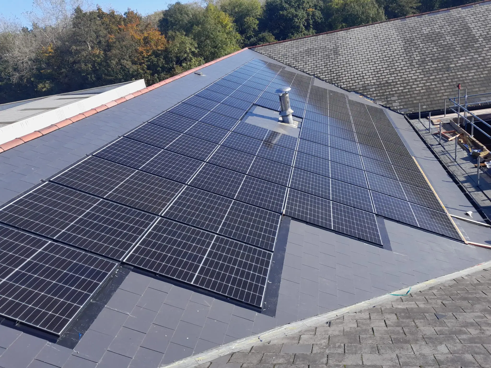 Completed 146 kWp commercial solar PV array on the workplace roof at New Directions Group, Cardiff