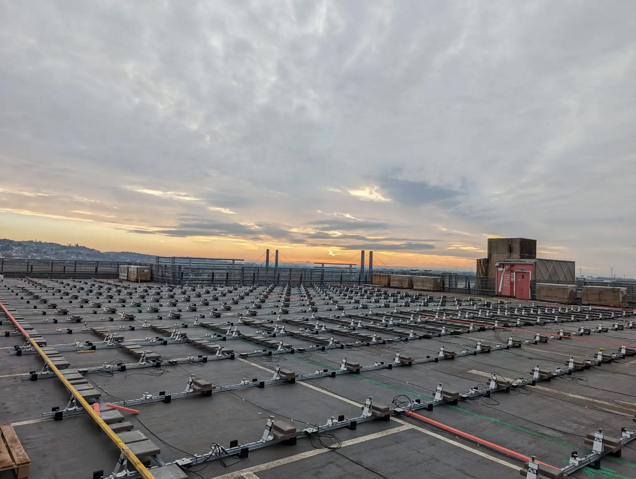 Solar PV mounting frames at sunrise, Newport Kingsway Centre rooftop.