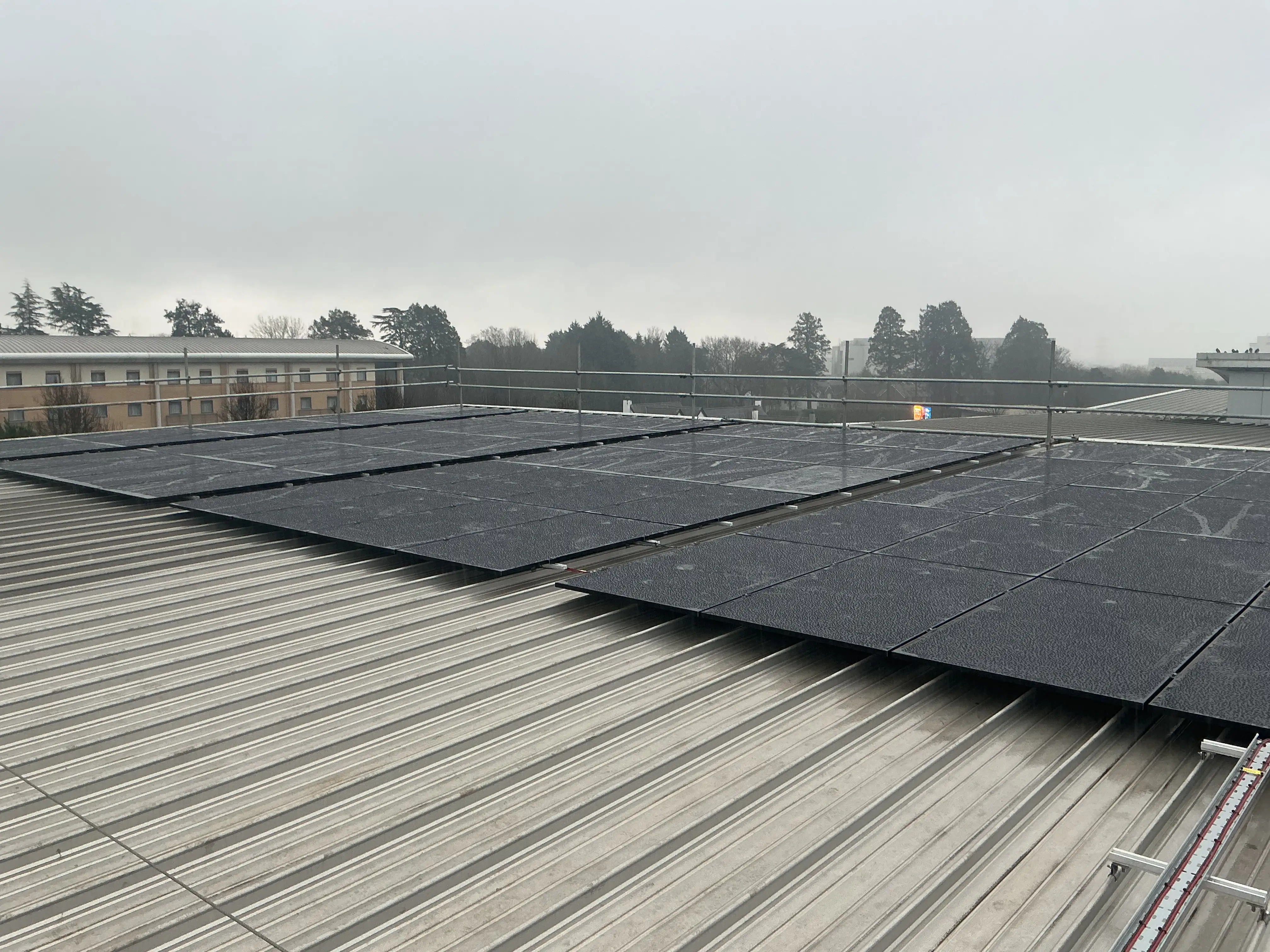 Rows of all-black solar panels rail-mounted on the metal roof of Wibli Wobli Nursery in Newport.
