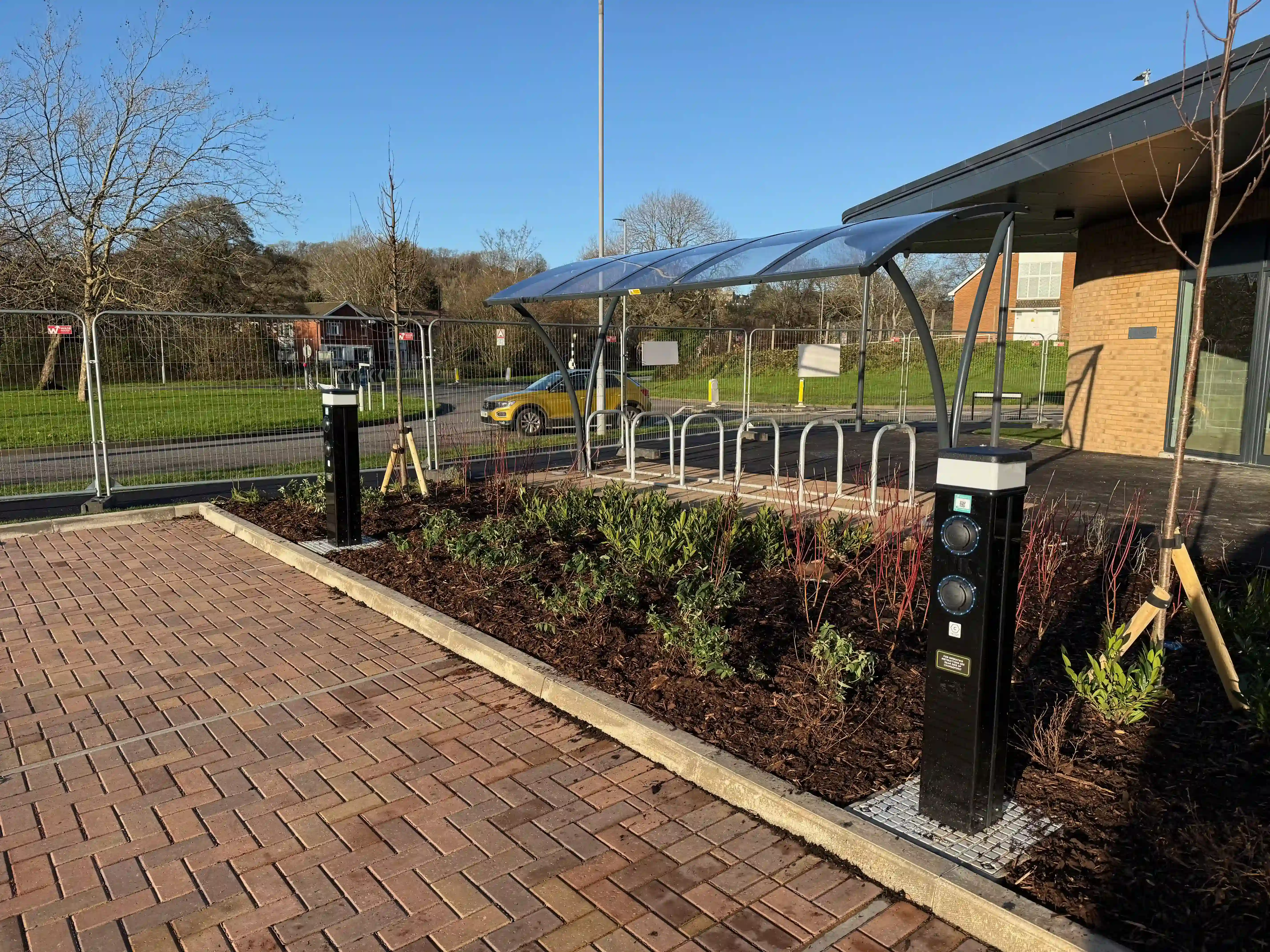 EV charging installation at a commercial development, with cycle shelter and landscaping in place.