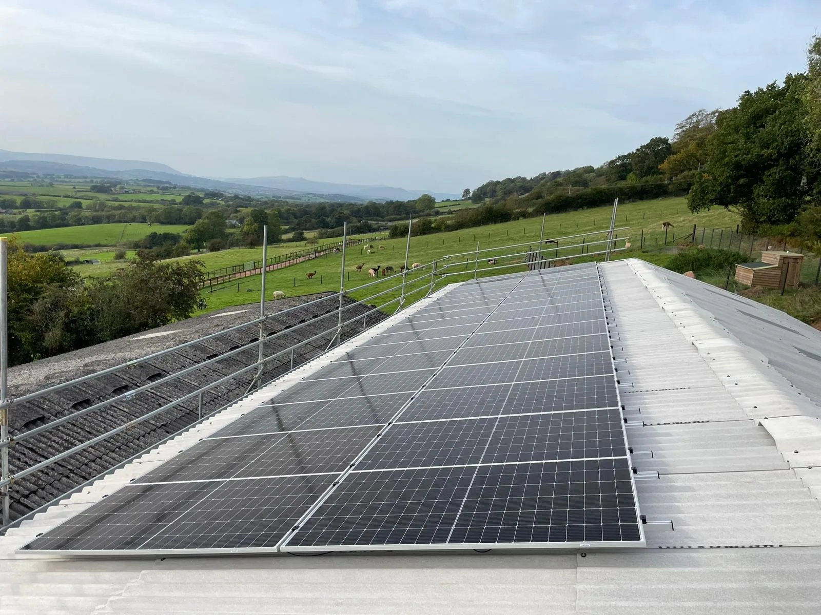 Agricultural solar PV installation on a farm building roof, providing on-site renewable energy for a rural business.