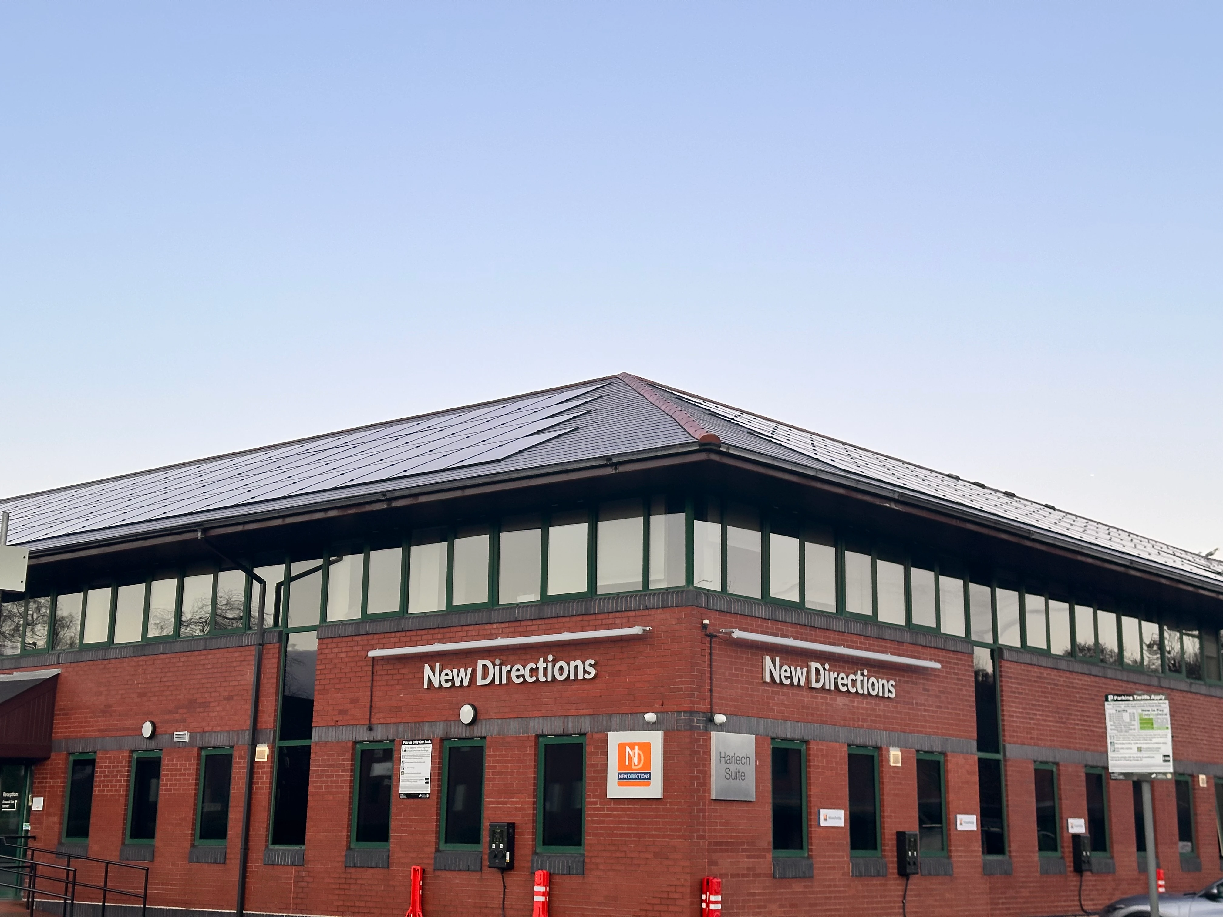 Commercial in-roof solar panel installation for New Directions, demonstrating integrated solar PV on a corporate office building.