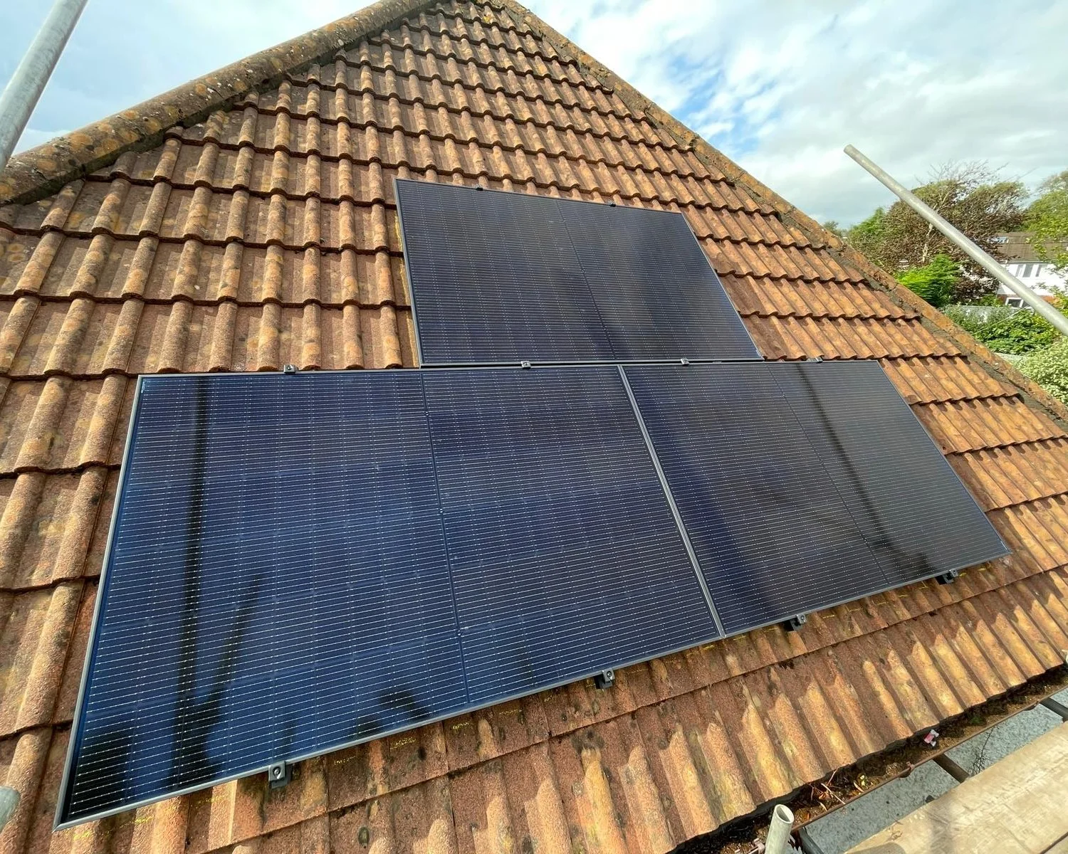 Solar panel installation on a tiled pitched roof, with three roof-mounted PV panels.