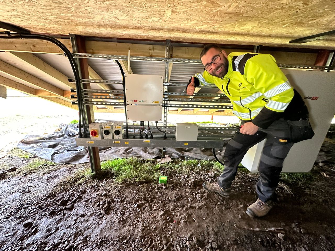 Solar PV maintenance and servicing by InspireGreen, with engineer carrying out routine checks on a SolarEdge inverter and battery storage system
