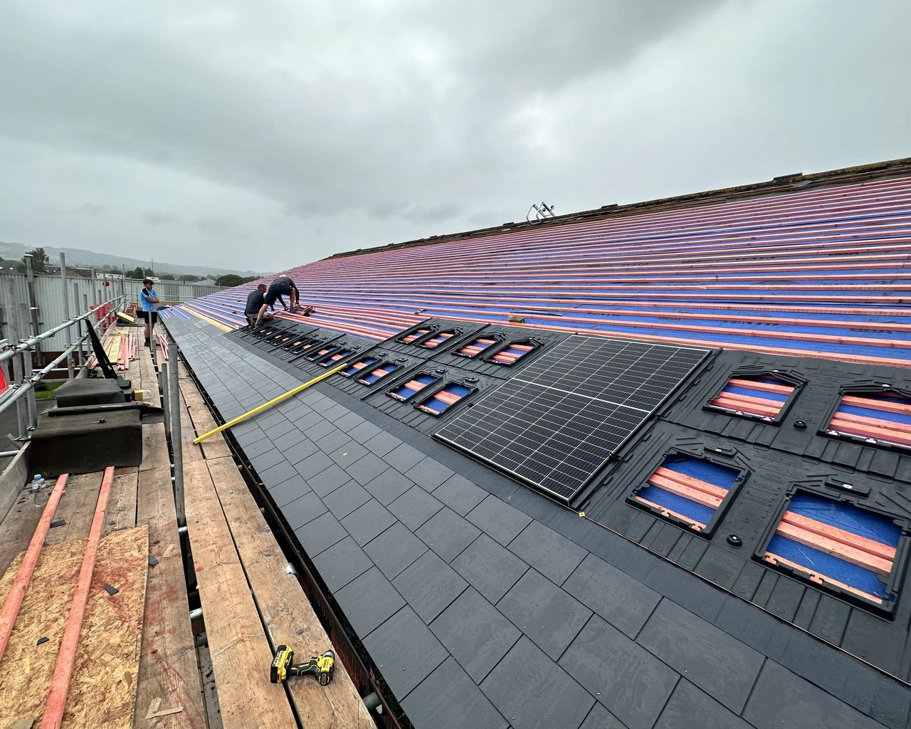 In-roof solar PV installation during a roof refurbishment, with panels integrated into a newly replaced roof.