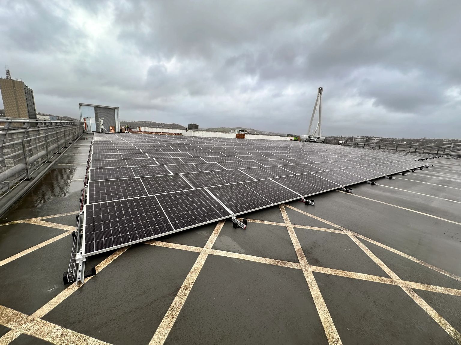 Commercial rooftop solar panel installation on a multi-storey car park, demonstrating renewable energy infrastructure on urban buildings.
