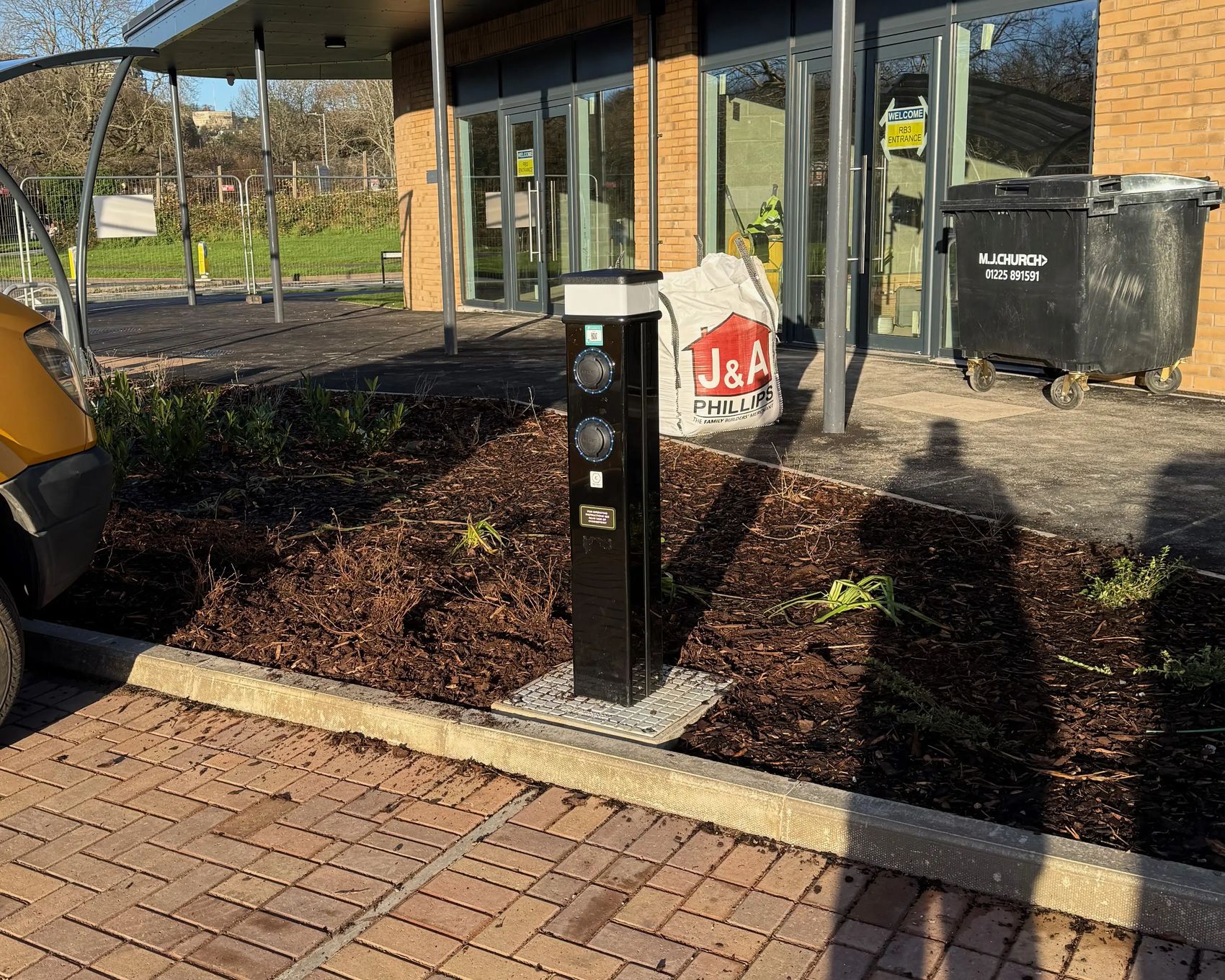 EV charging pedestal at a Hedyn housing site in Ringland, Newport, installed by InspireGreen, showing two Type 2 charging sockets by the entrance