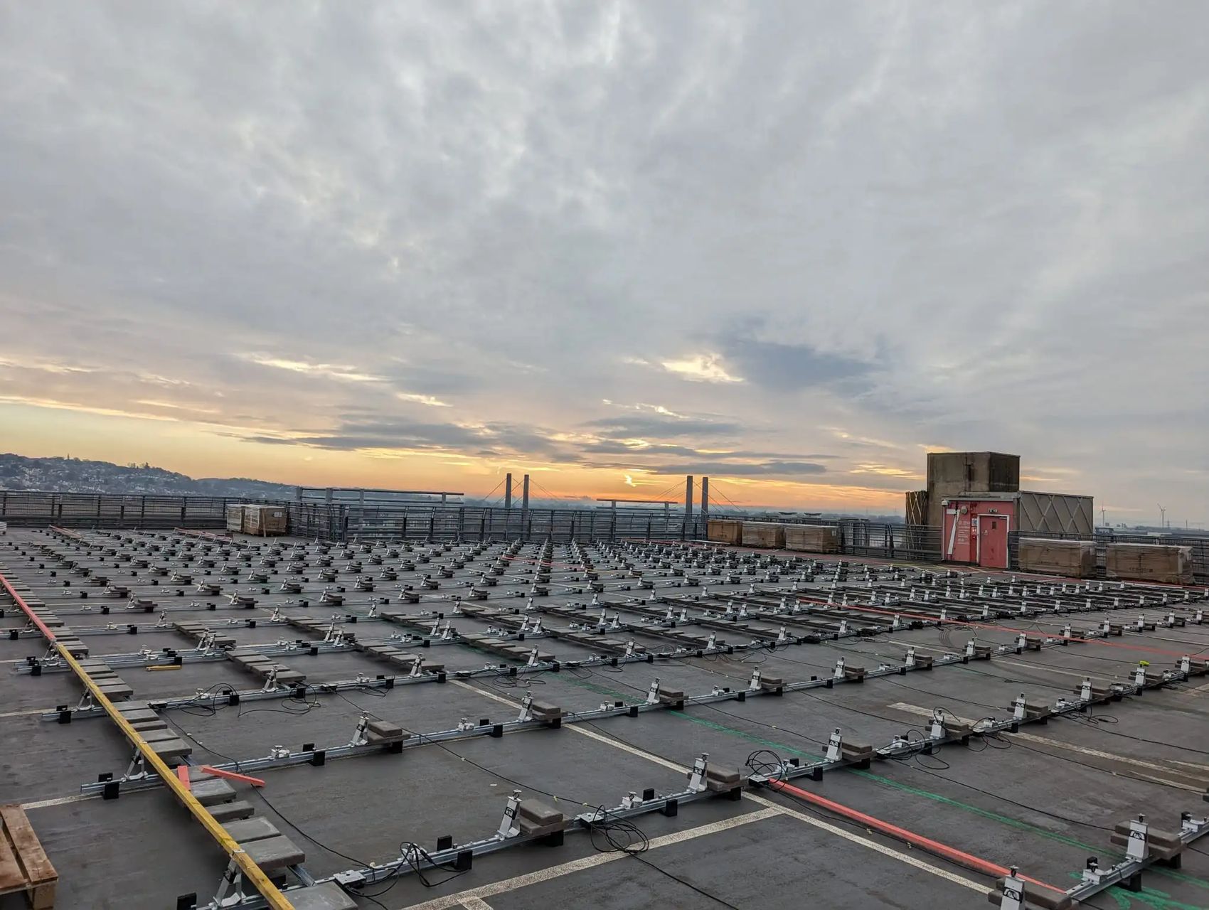 Solar PV mounting frames at sunrise, Newport Kingsway Centre rooftop.