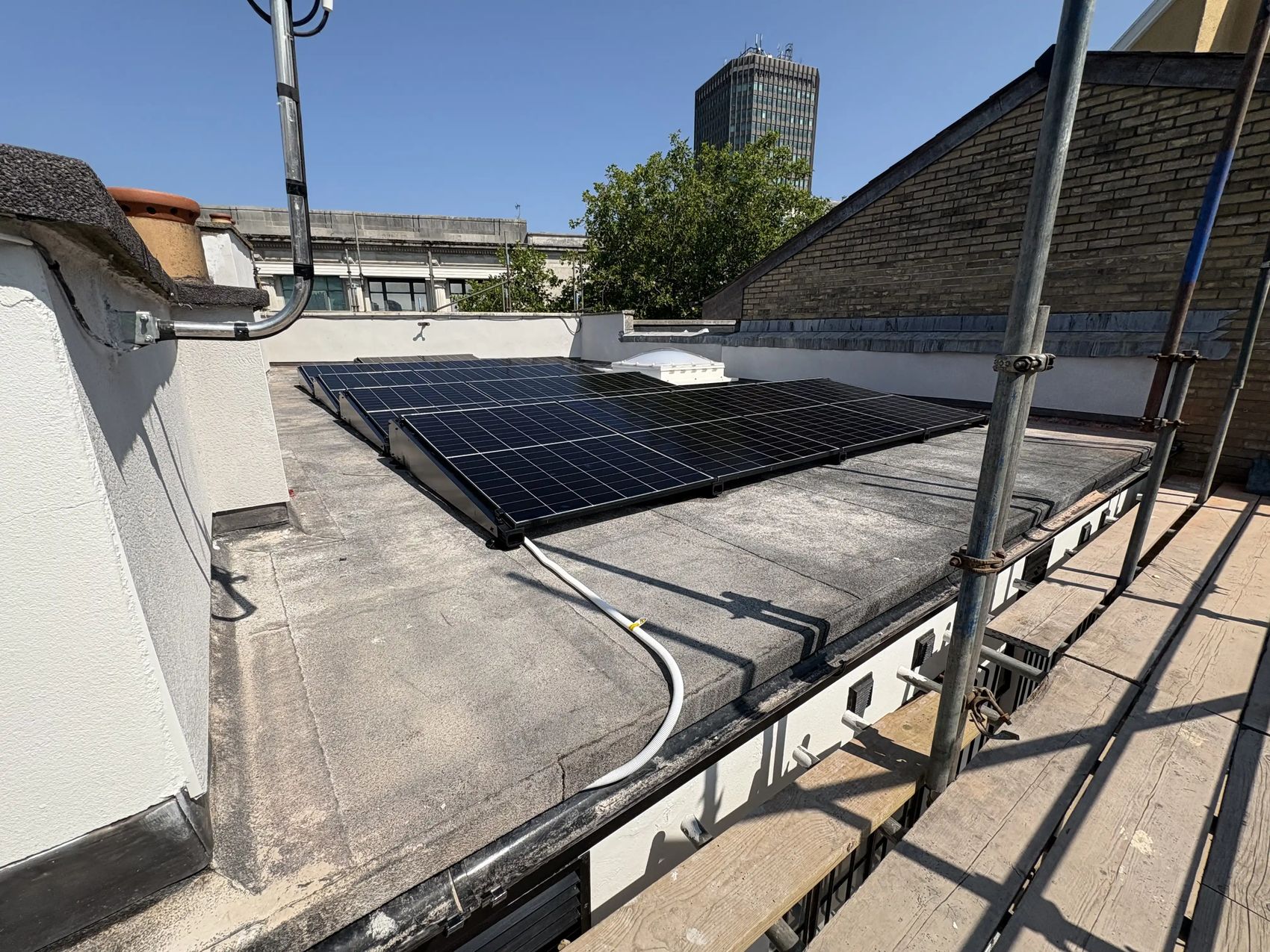 Completed rooftop solar PV array at Trailfinders' Cardiff travel centre with the city skyline behind