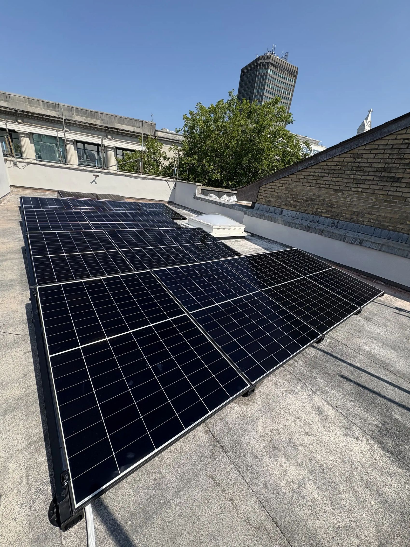 Completed rooftop solar PV array at Trailfinders' Cardiff travel centre under a clear sky
