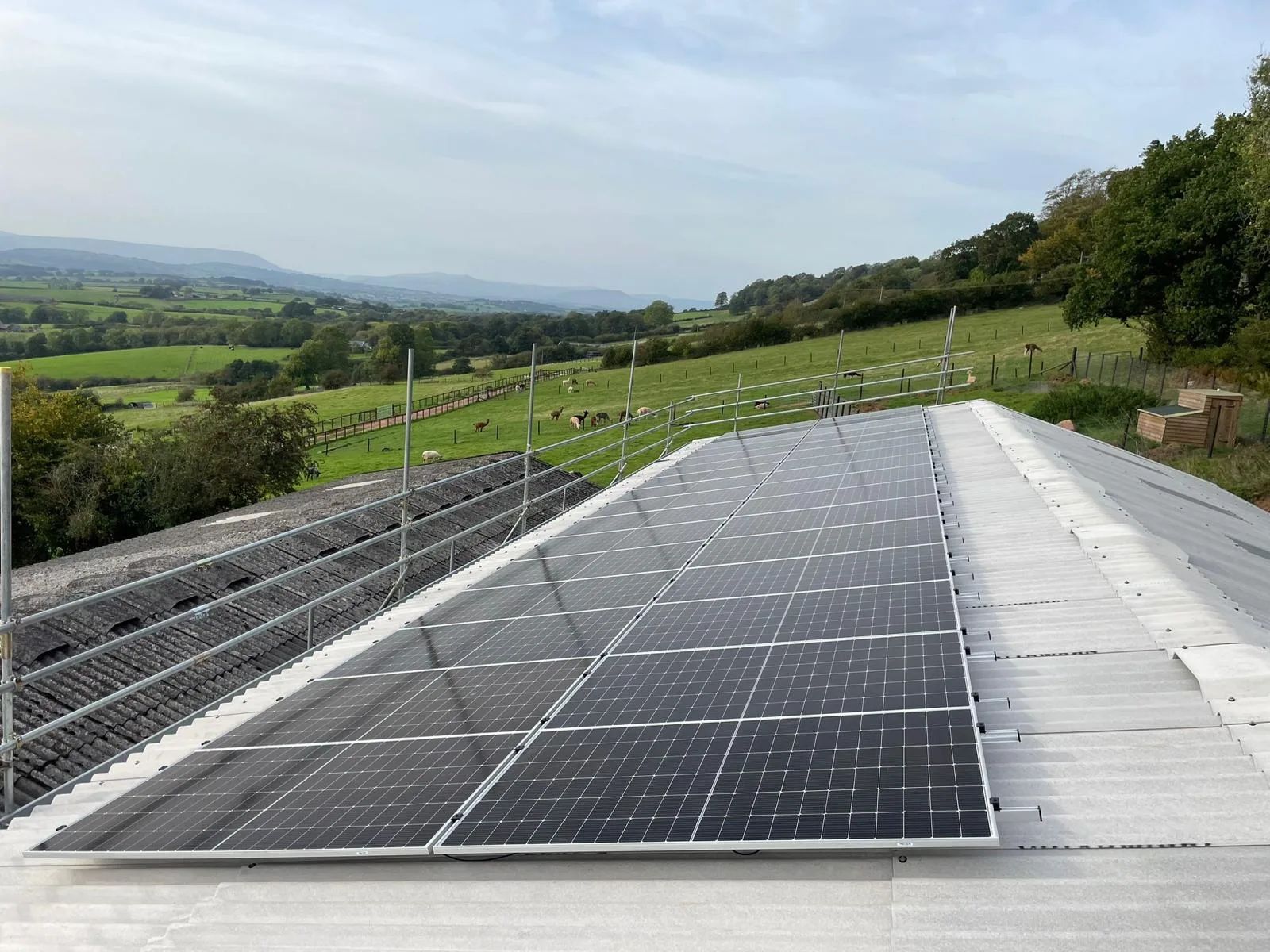 Agricultural solar PV installation on a farm building roof, providing on-site renewable energy for a rural business.