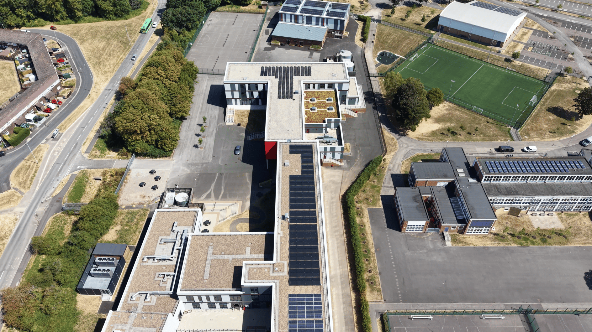 Overhead view of Ysgol Gyfun Gwent Is Coed showing solar panels across the roofs of its two main teaching wings