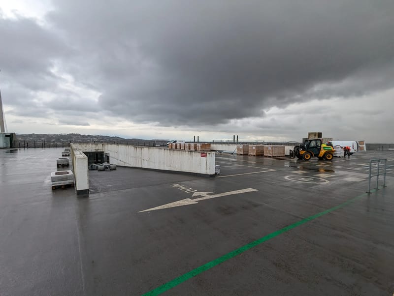 Solar panels being moved into position on the Kingsway Centre rooftop ahead of installation.