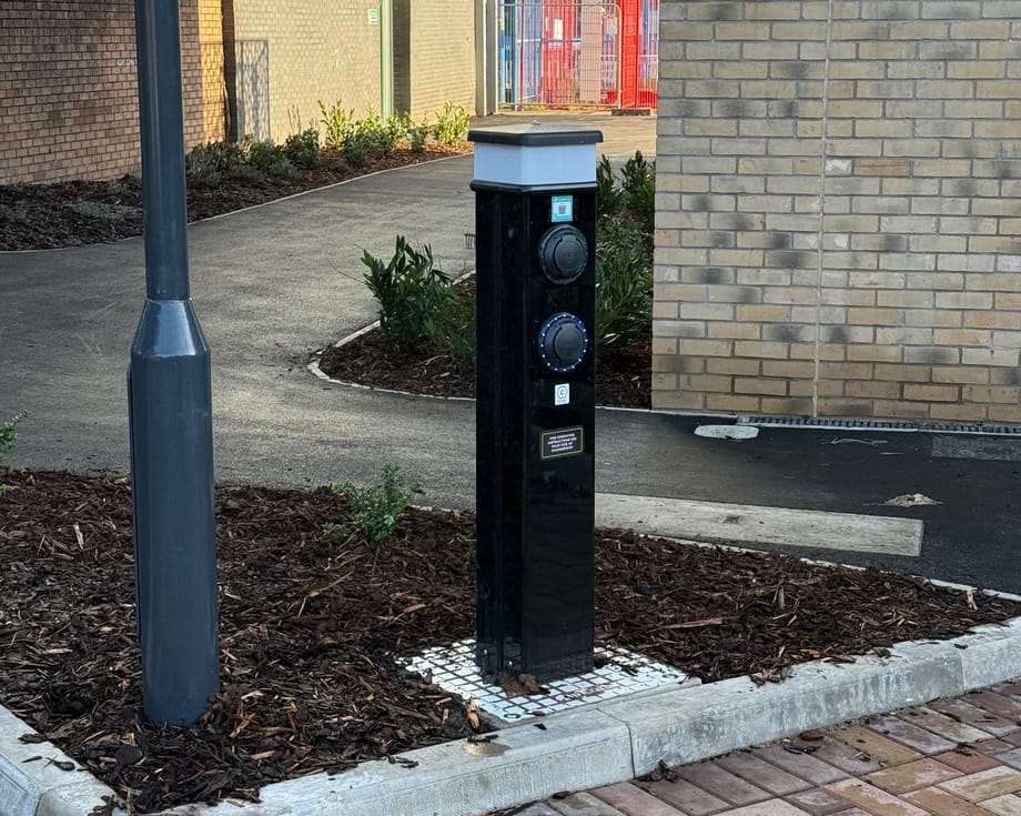 Black dual-socket EV charging pedestal installed by InspireGreen at a Hedyn residential site in Ringland, Newport