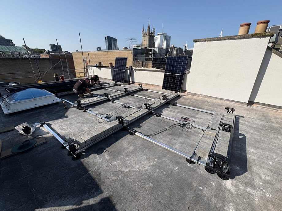 Solar panel mounting frame being installed on a rooftop in central Cardiff