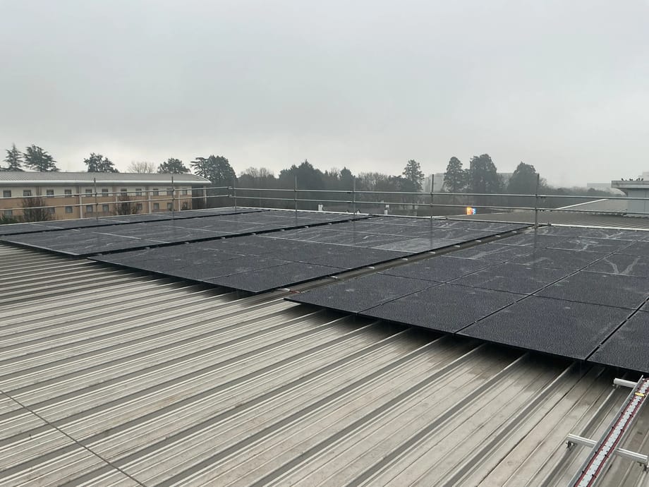 Rows of all-black solar panels rail-mounted on the metal roof of Wibli Wobli Nursery in Newport.
