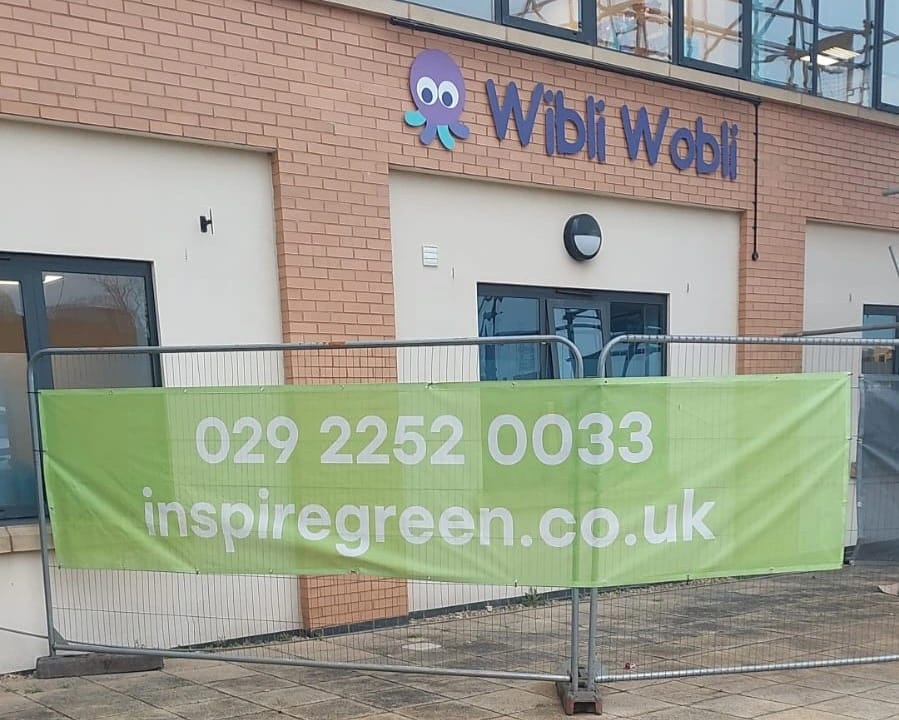 The Wibli Wobli Nursery building in Newport with an InspireGreen banner on the site fencing during the solar PV installation.